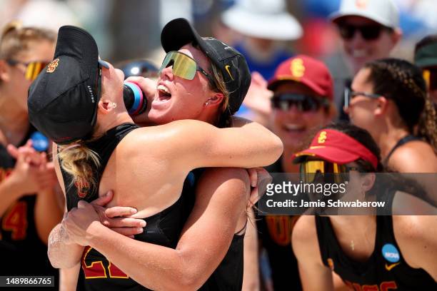 Madison Shields and Madison White of the USC Trojans celebrate with their teammates after winning their dual against the UCLA Bruins during the...