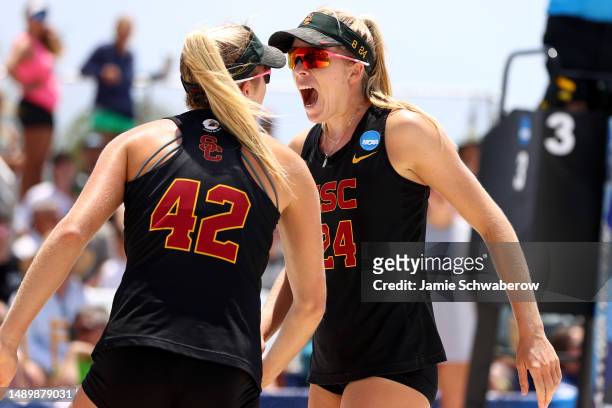 Audrey Nourse and Nicole Nourse of the USC Trojans celebrate a point against the UCLA Bruins during the Division I Womens Beach Volleyball...