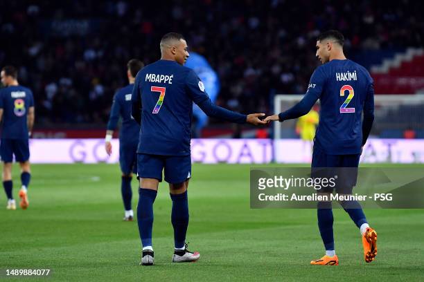 Kylian Mbappe of Paris Saint-Germain is congratulated by teammate Achraf Hakimi after scoring during the Ligue 1 match between Paris Saint-Germain...