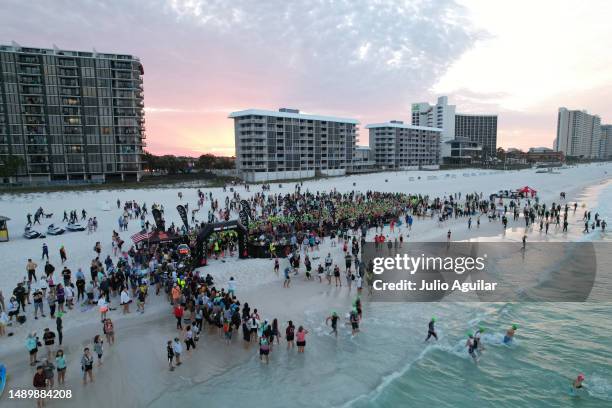 In an aerial view, athletes swim during the 2023 IRONMAN 70.3 Gulf Coast on May 13, 2023 in Panama City Beach, Florida.