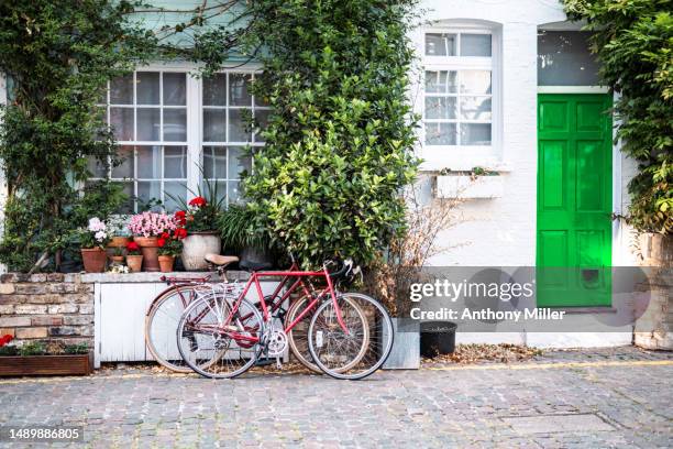 picturesque front of building with decorative green climbing plants on the house wall - doggie door stock pictures, royalty-free photos & images