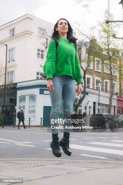 woman with rucksack levitating in a street - levitating stock pictures, royalty-free photos & images