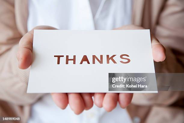a woman holding a card - gratitude symbol stock pictures, royalty-free photos & images