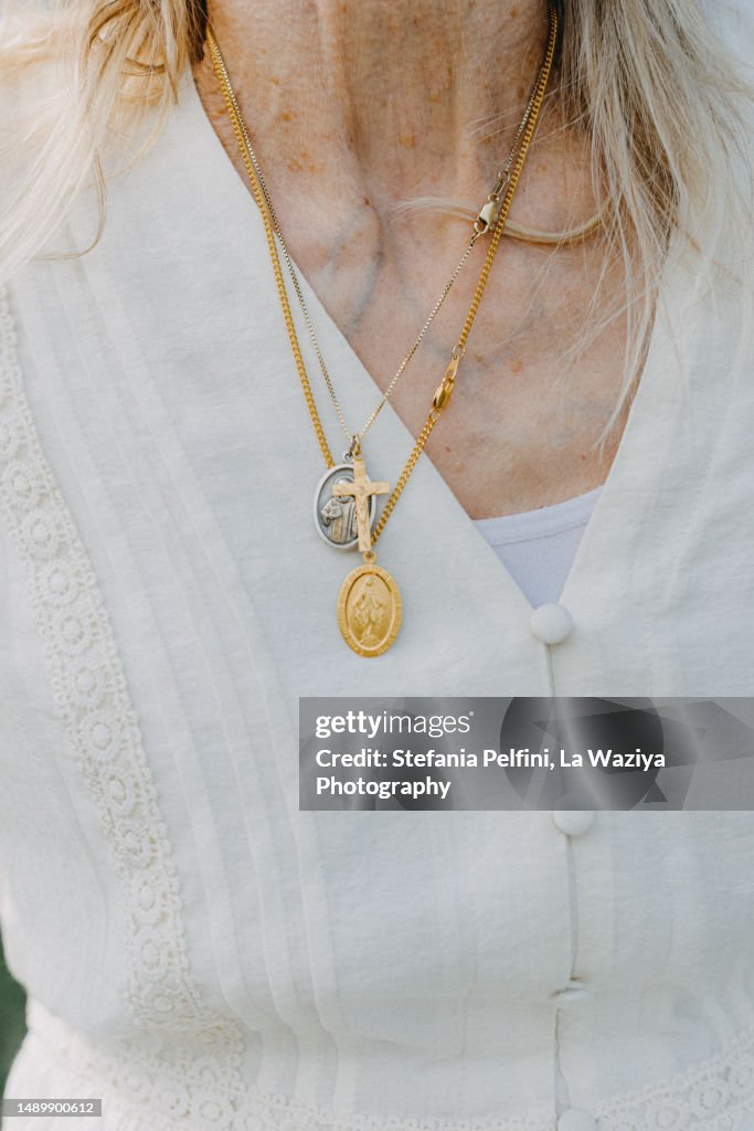 Christian Necklaces On White Shirt