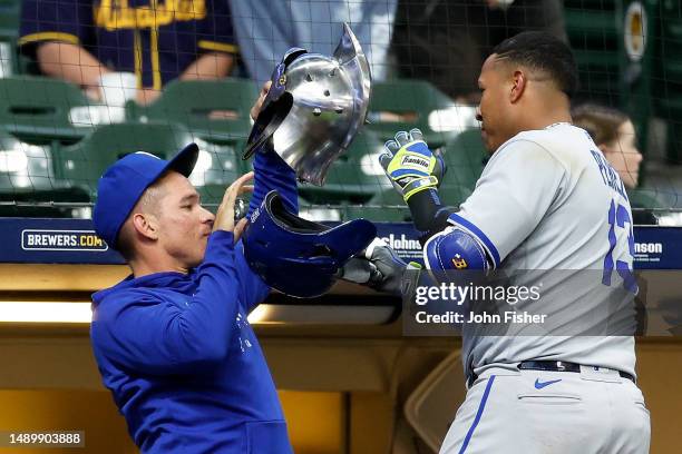 Salvador Perez of the Kansas City Royals exchanges helmets after hitting a solo home run in the fifth inning against the Milwaukee Brewers at...