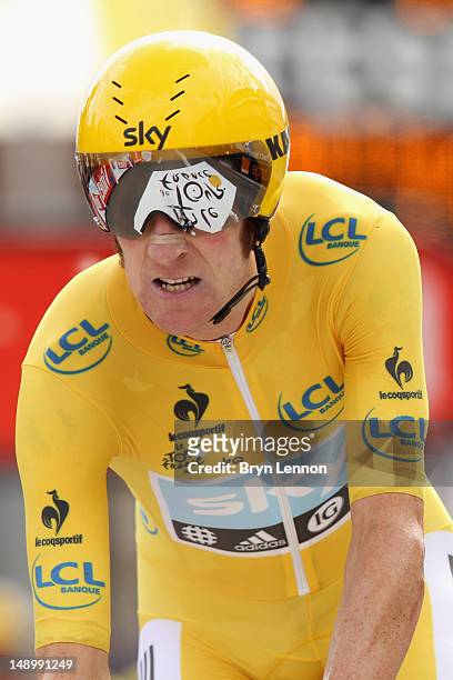 Bradley Wiggins of Great Britain and SKY Procycling crosses the line to winn the stage and secure the yellow jersey of the general classification...