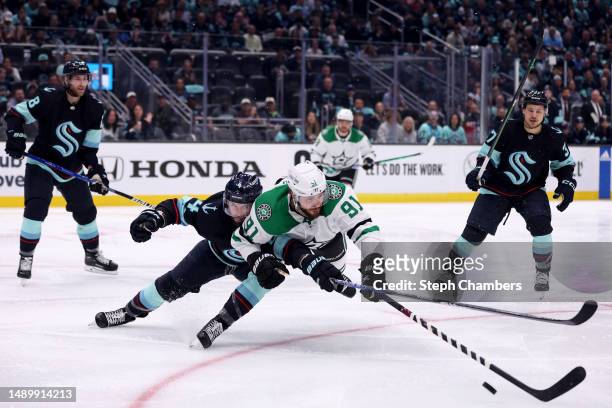 Justin Schultz of the Seattle Kraken defends Tyler Seguin of the Dallas Stars during the third period in Game Six of the Second Round of the 2023...