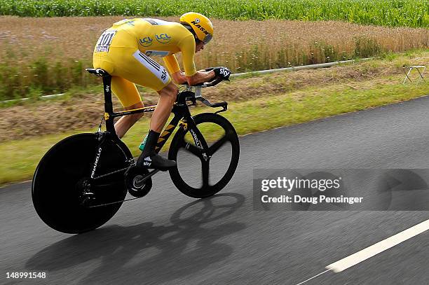 Bradley Wiggins of Great Britain riding for Sky Procycling races to first place in the individual time trial in stage nineteen and defends the race...