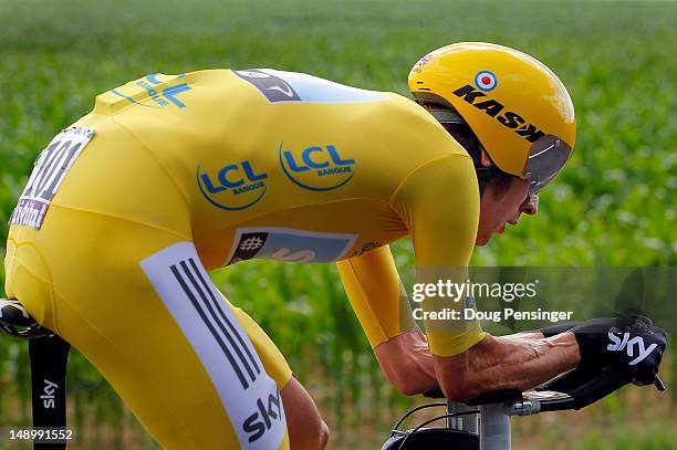 Bradley Wiggins of Great Britain riding for Sky Procycling races to first place in the individual time trial in stage nineteen and defends the race...