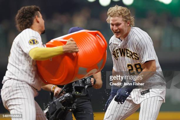 Joey Wiemer of the Milwaukee Brewers has Gatorade dumped on him by Willy Adames after Wiemer hit a sacrifice fly to win the game in the ninth inning...