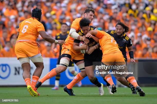 Shogo Nakano of Suntory Sungoliath is tackled during the Rugby League One playoff semi final between Kubota Spears Funabashi Tokyo Bay and Tokyo...