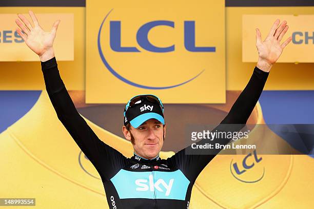 Bradley Wiggins of Great Britain and SKY Procycling celebrates on the podium after securing the yellow jersey of the general classification during...