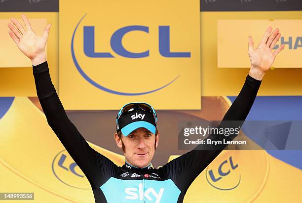 Bradley Wiggins of Great Britain and SKY Procycling celebrates on the podium after securing the yellow jersey of the general classification during...