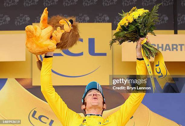 Bradley Wiggins of Great Britain and SKY Procycling celebrates on the podium after securing the yellow jersey of the general classification during...