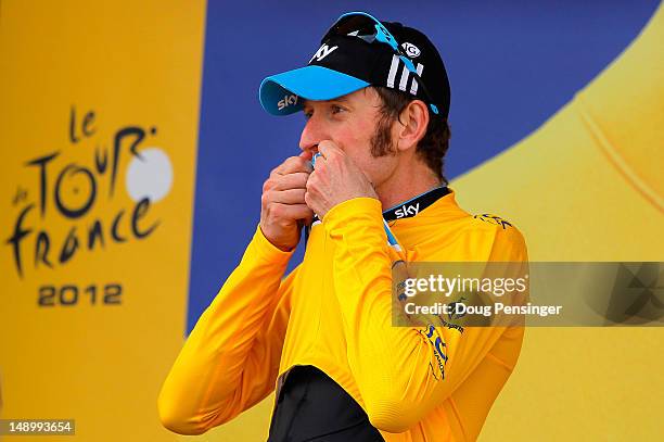 Bradley Wiggins of Great Britain riding for Sky Procycling kisses the race leader's yellow jersey after defending it with a win in the individual...