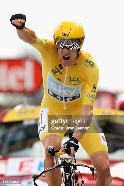 Bradley Wiggins of Great Britain and SKY Procycling punches the air with delight as he celebrates winning the stage and securing the yellow jersey of...