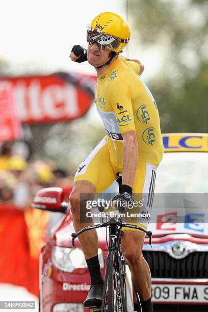 Bradley Wiggins of Great Britain and SKY Procycling punches the air with delight as he celebrates winning the stage and securing the yellow jersey of...