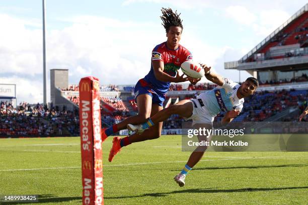 Dominic Young of the Knights catches a kick on his way to score a try during the round 11 NRL match between Newcastle Knights and Gold Coast Titans...