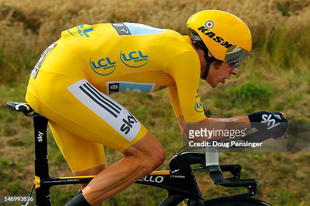 Bradley Wiggins of Great Britain riding for Sky Procycling races to first place in the individual time trial in stage nineteen and defends the race...
