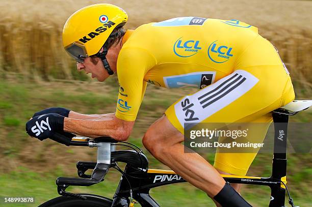 Bradley Wiggins of Great Britain riding for Sky Procycling races to first place in the individual time trial in stage nineteen and defends the race...