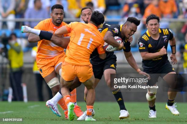 Kotaro Matsushima of Suntory Sungoliath is tackled by Haruto Kida of Kubota Spears during the Rugby League One playoff semi final between Kubota...