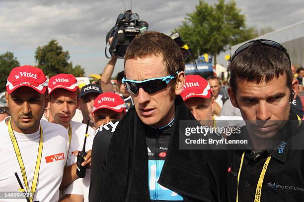 Bradley Wiggins of Great Britain and SKY Procycling makes his way to the podium after winning the stage and securing the yellow jersey of the general...