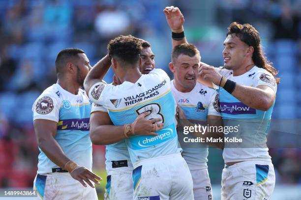 David Fifita of the Titans celebrates with his team mates after scoring a try during the round 11 NRL match between Newcastle Knights and Gold Coast...