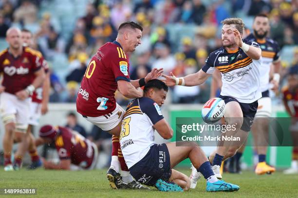 Freddie Burns of the Highlanders and Len Ikitau of the Brumbies clash during the round 12 Super Rugby Pacific match between ACT Brumbies and...