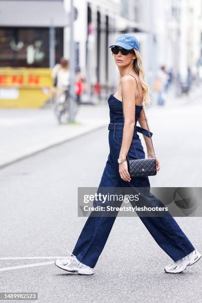 Model Annika Gassner, wearing a shoulder free Jenas Overall by Zara, a black bag by Chanel, a Jeans Cap by Off White, sneakers by New balance and...