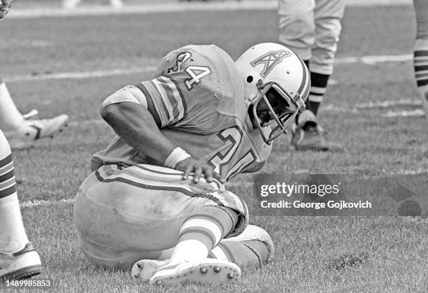 Running back Earl Campbell of the Houston Oilers puts his hand on his knee as he looks on from the field after he was tackled by the Cleveland Browns...