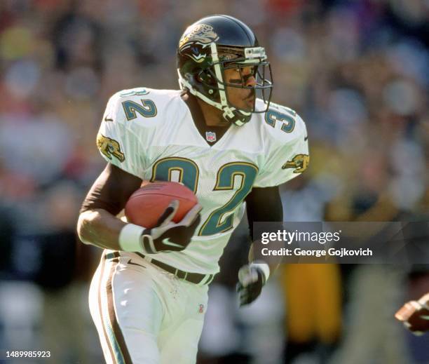 Kick returner Mike Logan of the Jacksonville Jaguars runs with the football against the Pittsburgh Steelers during a game at Three Rivers Stadium on...