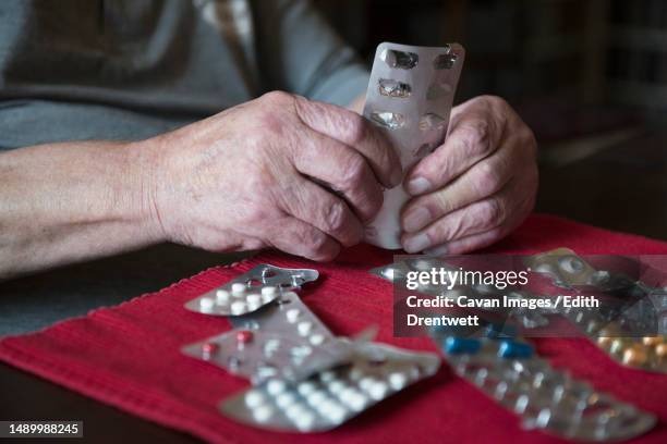 senior man with all his medication - vitamin sachet stock pictures, royalty-free photos & images