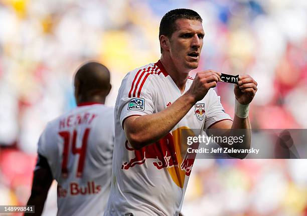 Kenny Cooper of the New York Red Bulls displays an armband printed with 'Reyna' after scoring a goal against the Philadelphia Union at Red Bull Arena...