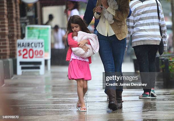 Suri Cruise seen walking in the rain in Chelsea on July 20, 2012 in New York City.