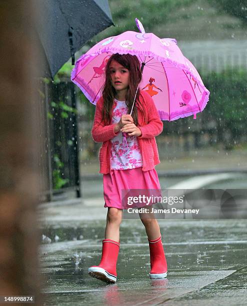 Suri Cruise seen walking in the rain in Chelsea on July 20, 2012 in New York City.