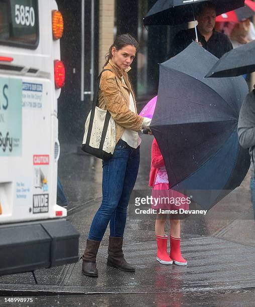 Katie Holmes and Suri Cruise seen walking in the rain in the Meat Packing District on July 20, 2012 in New York City.