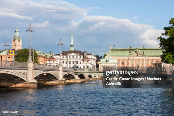 railway bridge with church in the background, storkyrkan, gamla stan, stockholm, sweden - stockholm old town stock pictures, royalty-free photos & images