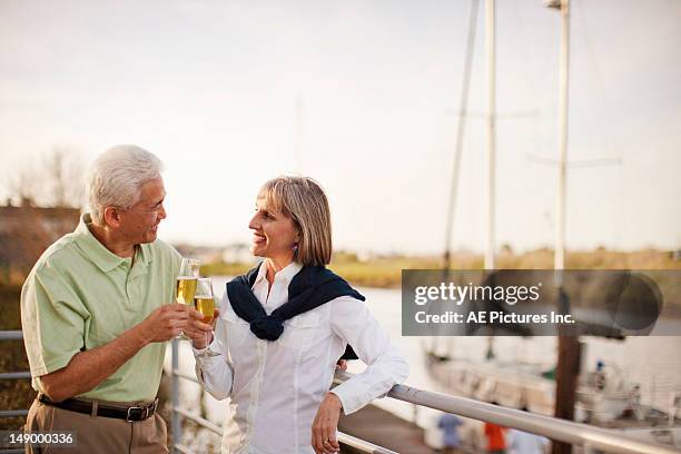 couple with champagne talking by a river - petaluma stock-fotos und bilder