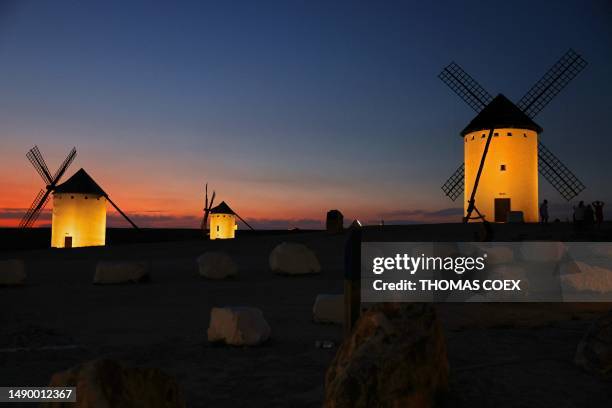 Ancient windmills are seen in the upper part of the village of Campo de Criptana, Castilla La Mancha region, central Spain, on July 3, 2023. The...