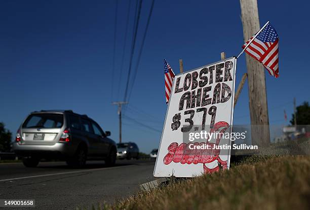 Sign advertising live lobsters for sale is displayed on the side of the road on July 21, 2012 in Portland, Maine. A mild winter and warmer than usual...