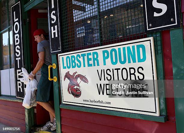 Customer leaves the Harbor Fish Market on July 21, 2012 in Portland, Maine. A mild winter and warmer than usual spring caused lobsters to shed their...