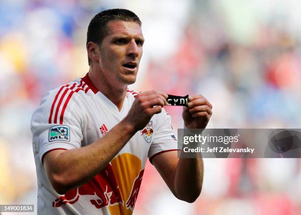 Kenny Cooper of the New York Red Bulls displays an armband printed with 'Reyna' after scoring a goal against the Philadelphia Union at Red Bull Arena...