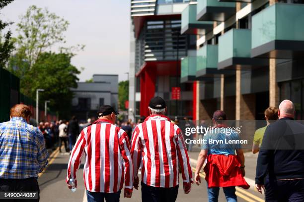 Fans of Brentford arrive at the stadium prior to the Premier League match between Brentford FC and West Ham United at Gtech Community Stadium on May...