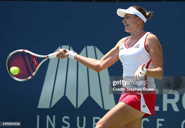 Nadia Petrova of Russia returns a shot to Dominka Cibulkova of Slovakia in their semifinal match during day eight of the Mercury Insurance Open...