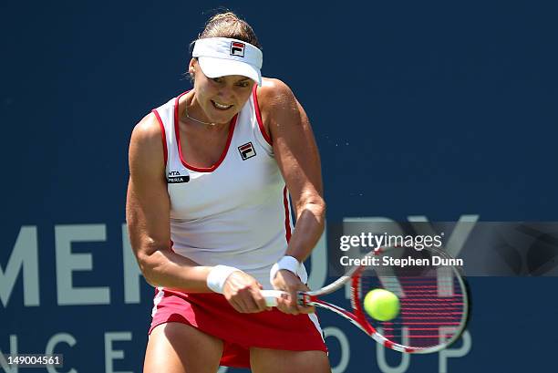 Nadia Petrova of Russia returns a shot to Dominka Cibulkova of Slovakia in their semifinal match during day eight of the Mercury Insurance Open...