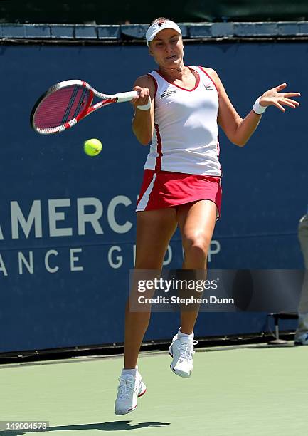 Nadia Petrova of Russia returns a shot to Dominka Cibulkova of Slovakia in their semifinal match during day eight of the Mercury Insurance Open...