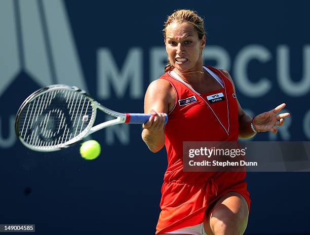 Dominka Cibulkova of Slovakia returns a shot to Nadia Petrova of Russia in their semifinal match during day eight of the Mercury Insurance Open...