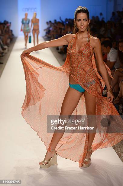 Model walks the runway at the Caffe Swimwear show during Mercedes-Benz Fashion Week Swim 2013 at The Raleigh on July 21, 2012 in Miami Beach, Florida.