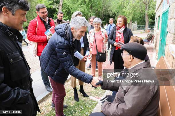 Interior Minister Fernando Grande Marlaska greets a neighbor on his arrival at a PSOE rally at the Parque Infantil de Trafico on May 14 in Avila,...