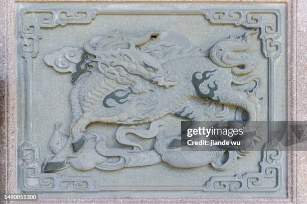 the ancient chinese mascot kirin carved on the wall - dragon cartoon stock pictures, royalty-free photos & images